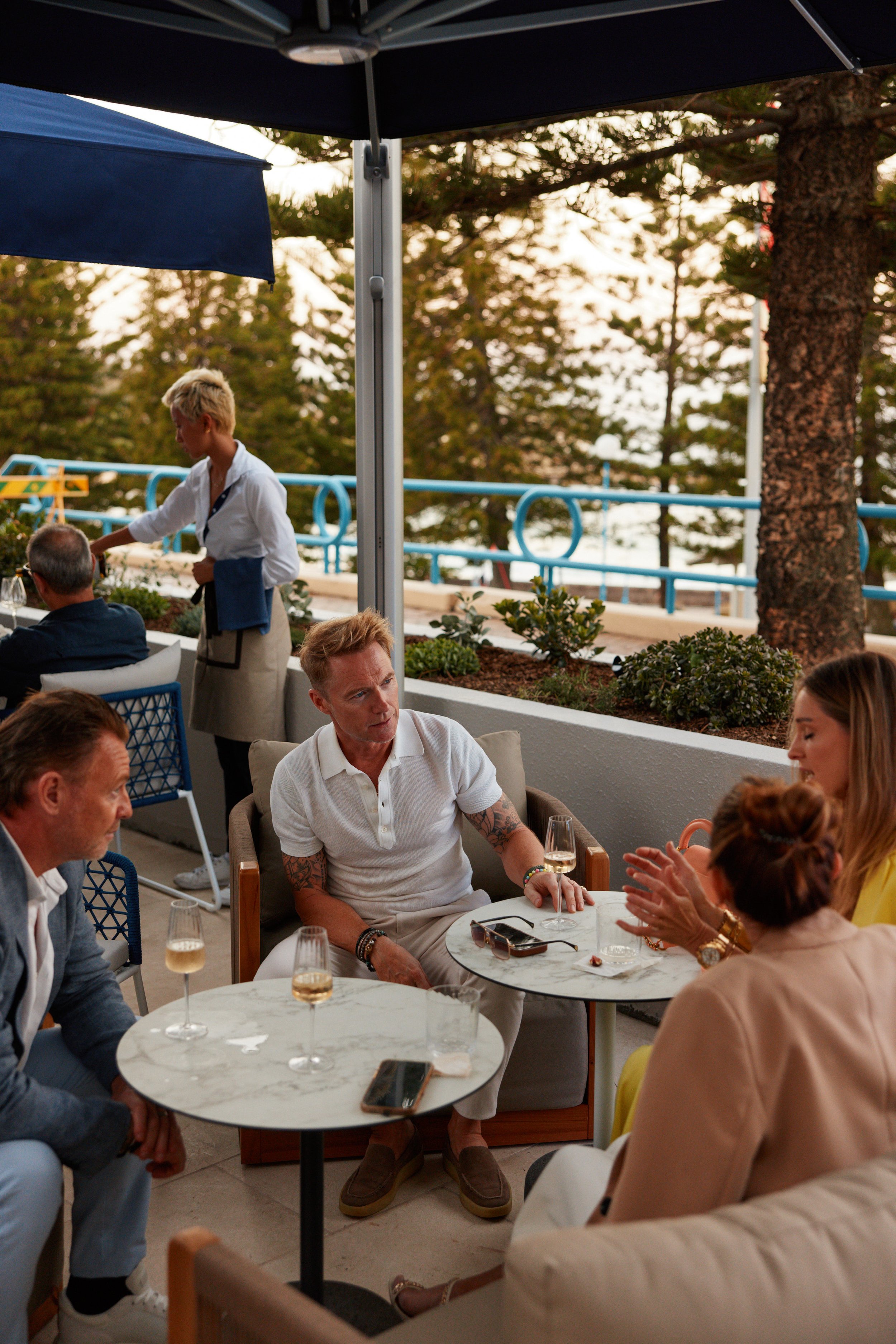 Guests sit under umbrellas on The Terrace at Rick Stein at Coogee Beach.