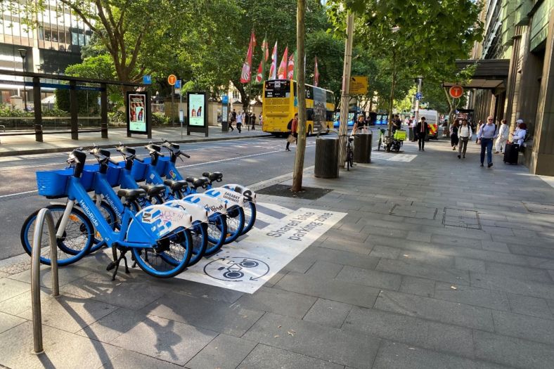 A marked shared e-bike parking bay near a Sydney transport hub, shown in NSW Government pilot material.
